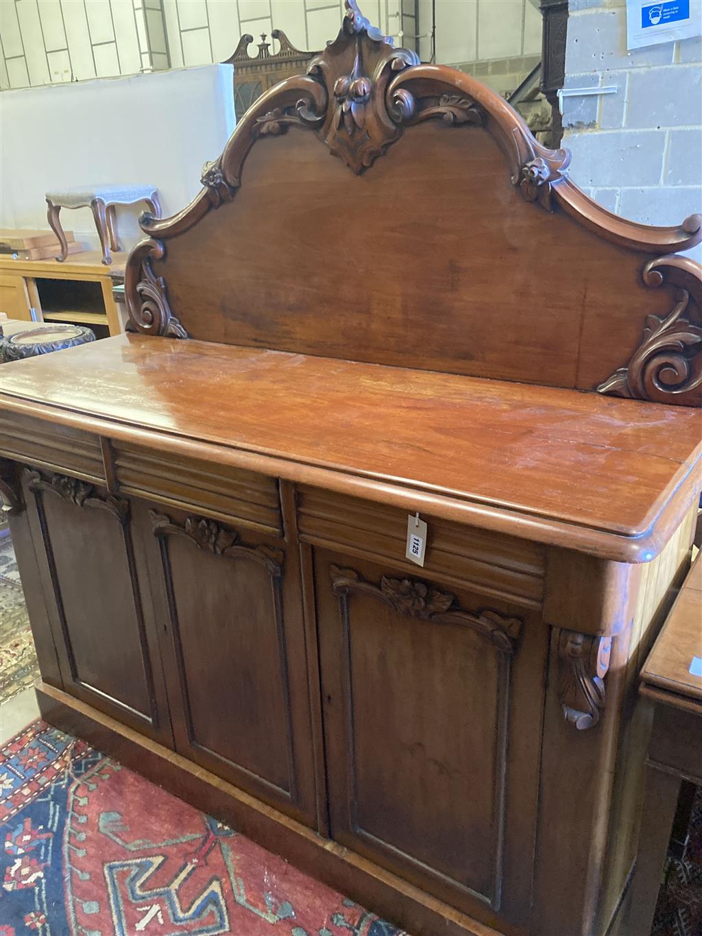 A Victorian carved mahogany sideboard fitted drawers and cupboard, length 150cm, depth 56cm, height 166cm
